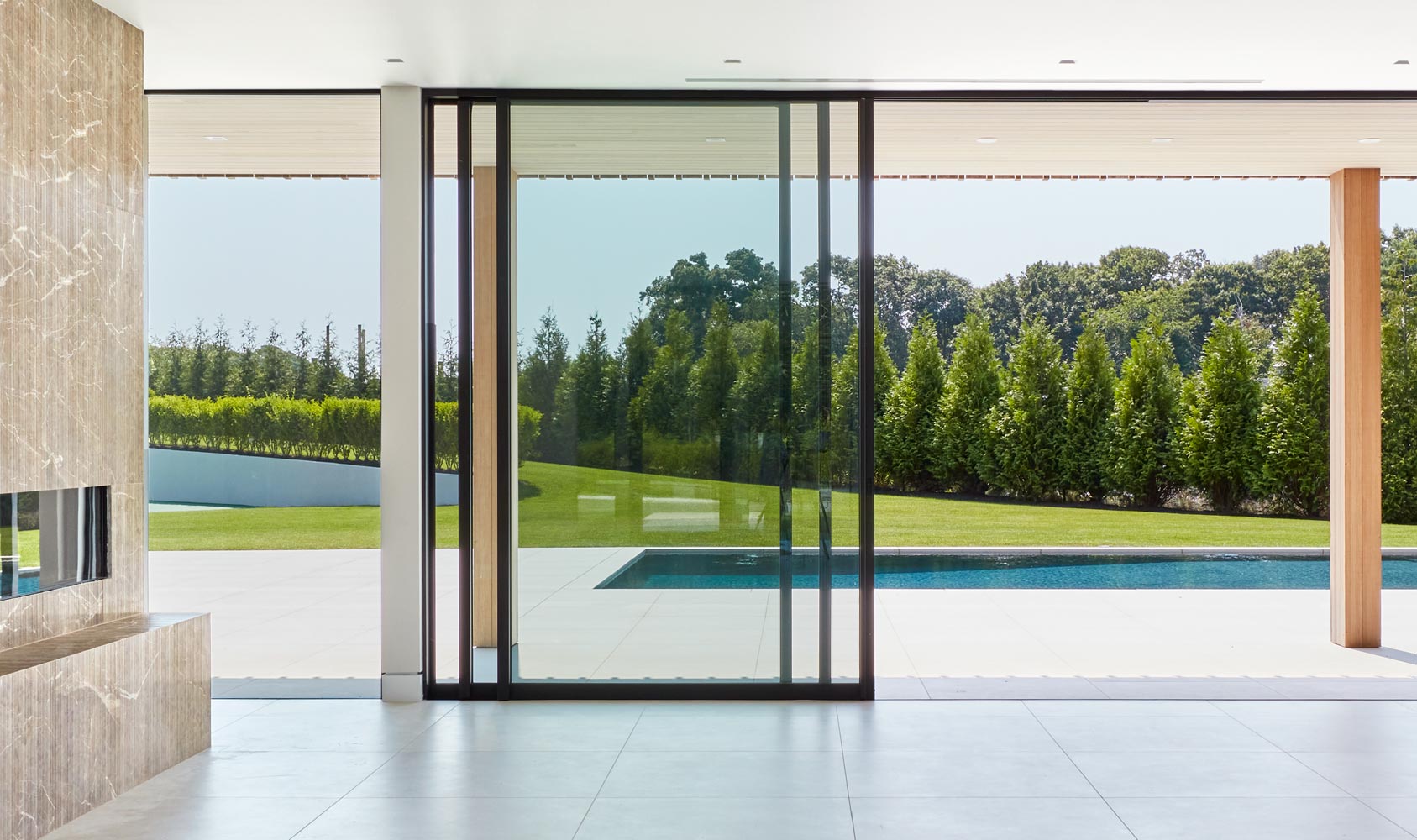 sliding glass door wall in rear of argicultural modern farmhouse