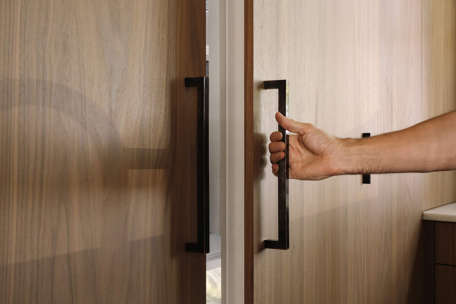 Clean, minimal walnut flat panel kitchen cabinetry