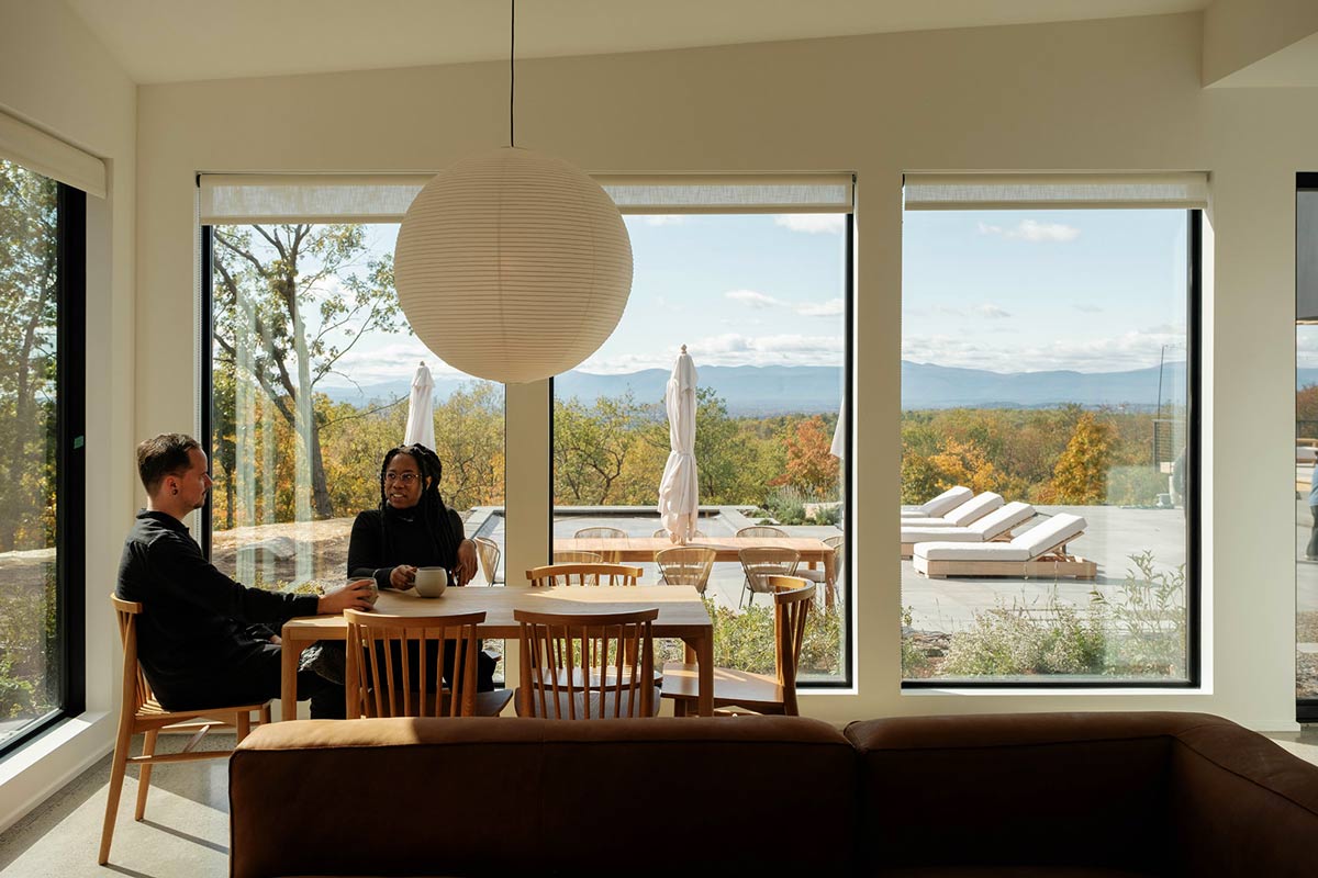 drinking coffee in front of mountain views from modern hudson valley home interiors